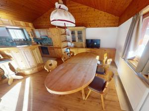 a dining room with a wooden table and chairs at Haus Conny in Zell am See