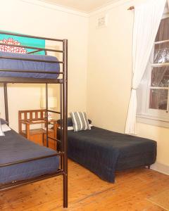 a bedroom with two bunk beds and a window at Katoomba Mountain Lodge in Katoomba