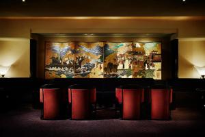 a large painting on the wall in a room with chairs at Hotel New Otani Osaka in Osaka +123 photos