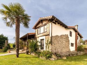 OruñaChalet Suka的一栋前面有棕榈树的房子