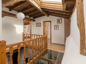 a wooden staircase in a house with a vaulted ceiling at Chalet Suka in Oruña