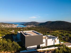 ein Haus auf einem Hügel mit Meerblick in der Unterkunft Villa Koko Vinišće with heated pool and sea view in Vinišće