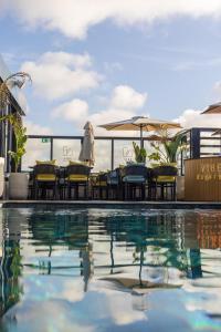 a swimming pool with chairs and umbrellas on a building at Courtyard by Marriott Casablanca Downtown in Casablanca
