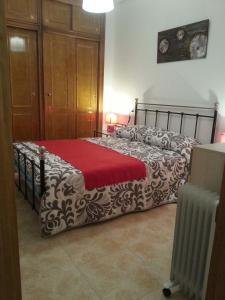 a bedroom with a bed with a red blanket at Apartment Huerto in Torrevieja