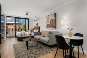 a living room with a couch and a table at Newlands Peak Apartments in Cape Town +291 photos