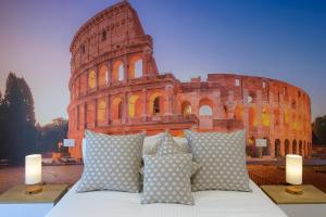 a bed with pillows in front of the leaning tower at Luxury Suite-Metro Malatesta in Rome