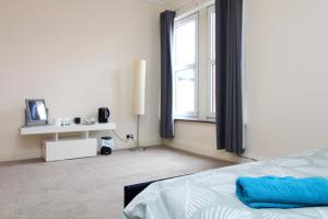 a bedroom with a bed and a large window at Darwin road guest house 3 in Southampton