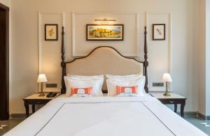 a bedroom with a large white bed with two tables at The Hills collective with private plunge pool My Downtown Hotel in Udaipur +36 photos
