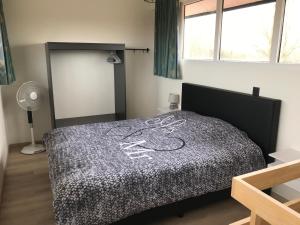 a bedroom with a bed with aigil on it at Vakantiewoning De Zandkorrel in Middelkerke