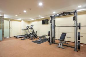 a gym with several treadmills and tread machines at Hotel Coia de Vigo in Vigo