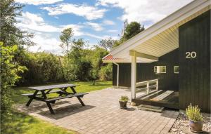 a picnic table next to a building with a bench at Holiday Home Humble 34 With Hot Tub in Humble