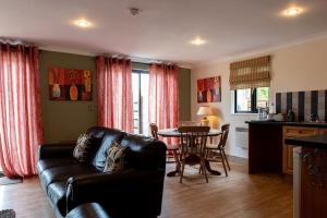 a living room with a couch and a table at Harvest 1 Lodge, Yellowtop Country Park in Selby