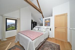 a bedroom with a bed and a window at La maison Poulogne in Capvern