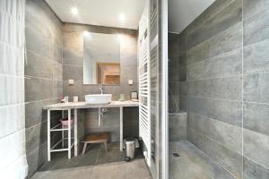 a bathroom with a sink and a mirror at La maison Poulogne in Capvern +22 photos