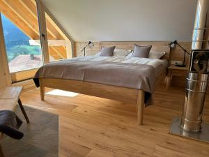 a bedroom with a bed and a large window at Nock Chalets in Afritz