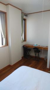 Postel nebo postele na pokoji v ubytování リンゴテラス壺屋