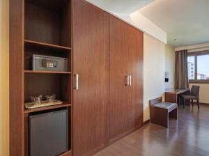 a room with a cabinet with a microwave in it at Hotel Coia de Vigo in Vigo