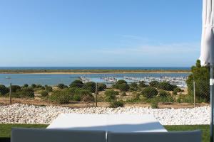 a view of the ocean from the balcony of a resort at Garden Playanatural - Adults Only in El Rompido