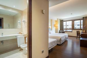 a hotel room with a bed and a bathroom at Hotel Coia de Vigo in Vigo