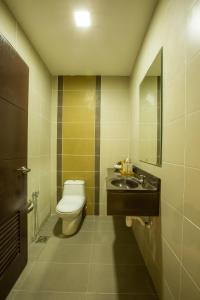 a bathroom with a toilet and a sink at Humaira Hotel in Tanah Merah