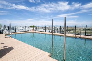 a large swimming pool on top of a building at INNSiDE by Meliá Madrid Valdebebas in Madrid