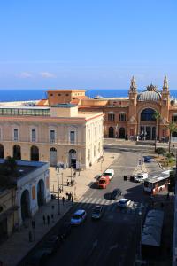 a city street with cars parked in front of a building at Margherita's House in Bari