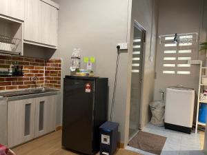 a kitchen with a refrigerator and a sink at ZD Homestay Pekan in Pekan +29 photos