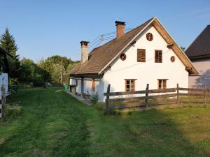 a white house with a fence in the yard at URige Hütte in Maria Elend