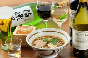 a bowl of soup and two glasses of wine at Richmond Hotel Premier Sendai Ekimae in Sendai