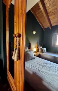 a bedroom with a bed and a mirror at Casita en Estavar in Estavar +15 photos