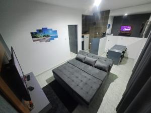 a living room with a couch and a television at Adriana Beach in Ilha Comprida