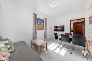 a living room with a table and a dining room at KozyGuru | Thornleigh | Charming Two-Bed Townhouse in Thornleigh