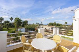 a patio with a table and chairs on a balcony at Villa Juana in Can Picafort