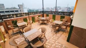 a patio with tables and chairs on a balcony at Hotel Tango Traxx in Amritsar +22 photos
