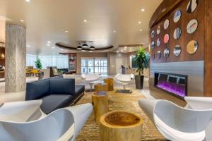 a living room filled with furniture and a fireplace at Cambria Hotel Milwaukee Downtown in Milwaukee
