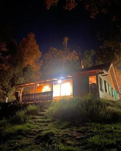 a cabin at night with the lights on at Pico Andino in San Carlos de Bariloche