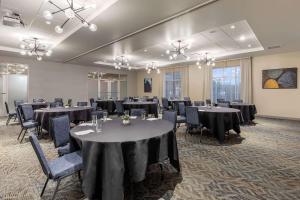 a banquet room with tables and chairs with black table cloth at Cambria Hotel Milwaukee Downtown in Milwaukee +39 photos