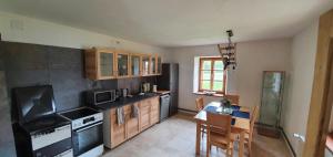a kitchen with a table and a dining room at URige Hütte in Maria Elend +45 photos
