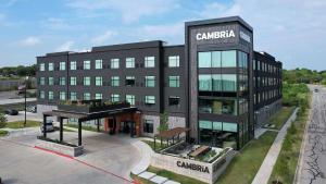 a large black building with a sign on it at Cambria Hotel Austin Airport in Austin