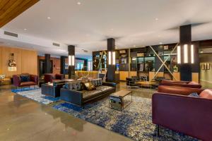 a large living room with couches and chairs at Cambria Hotel Austin Airport in Austin