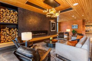 a living room filled with furniture and a fireplace at Cambria Hotel Austin Airport in Austin