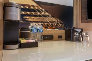 a kitchen with bottles of water on a counter at Cambria Hotel Austin Airport in Austin