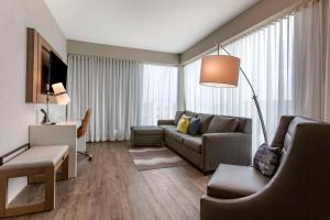 a living room with a couch and a table at Cambria Hotel Austin Airport in Austin