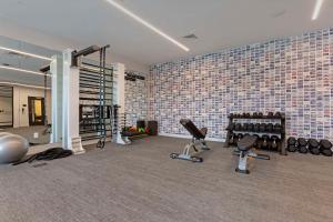 a gym with several treadmills and exercise equipment at Cambria Hotel Austin Airport in Austin