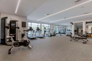 a gym with several treadmills and exercise bikes at Cambria Hotel Austin Airport in Austin