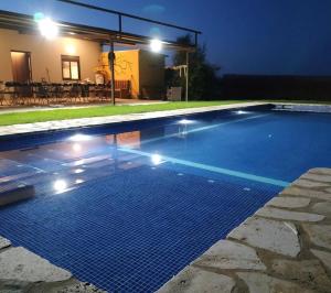 a swimming pool at night with lights on it at Casa Rural Granja Abril in Cardiel de los Montes