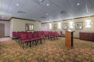 a conference room with red chairs and a podium at Country Inn & Suites by Radisson, Emporia, VA in Emporia +27 photos