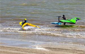 two people are in the water with at Stunning Apartment In Santa Pola in Santa Pola