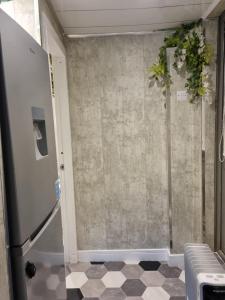 a bathroom with a refrigerator and a tile floor at Studio Near Beach Garden Parking PetsOK in Sunderland +4 photos