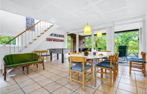 a dining room with a table and chairs at Three-Bedroom Holiday Home In Grenaa in Grenå